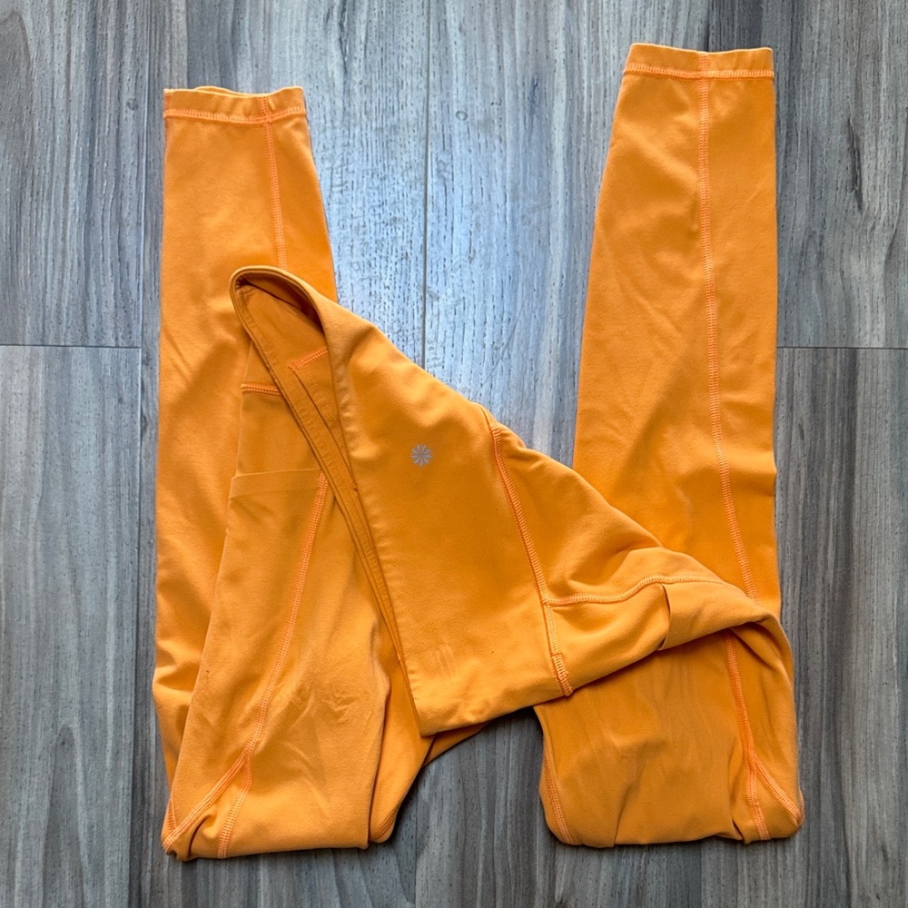 Athleta Golden Activewear Stash Pocket salutation tight with powervita fabric